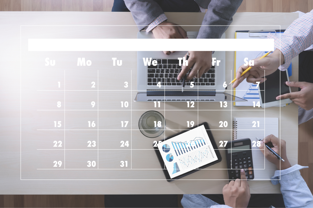 Business meeting with a calendar overlay, showing hands working on laptops, documents, and calculators.